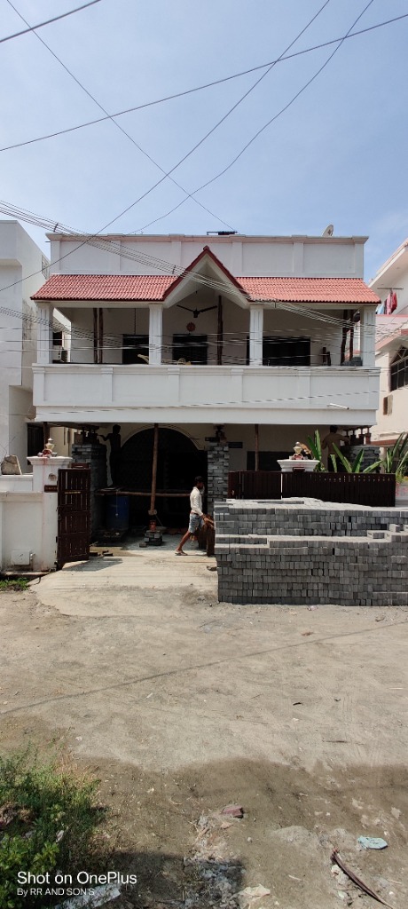 Two-storey residential house lifted above road level with paving stone cribbing (Wide Perspective)